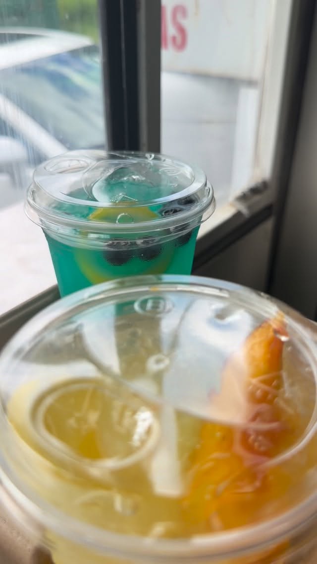 Blue and peach Factory lemonades in clear cups